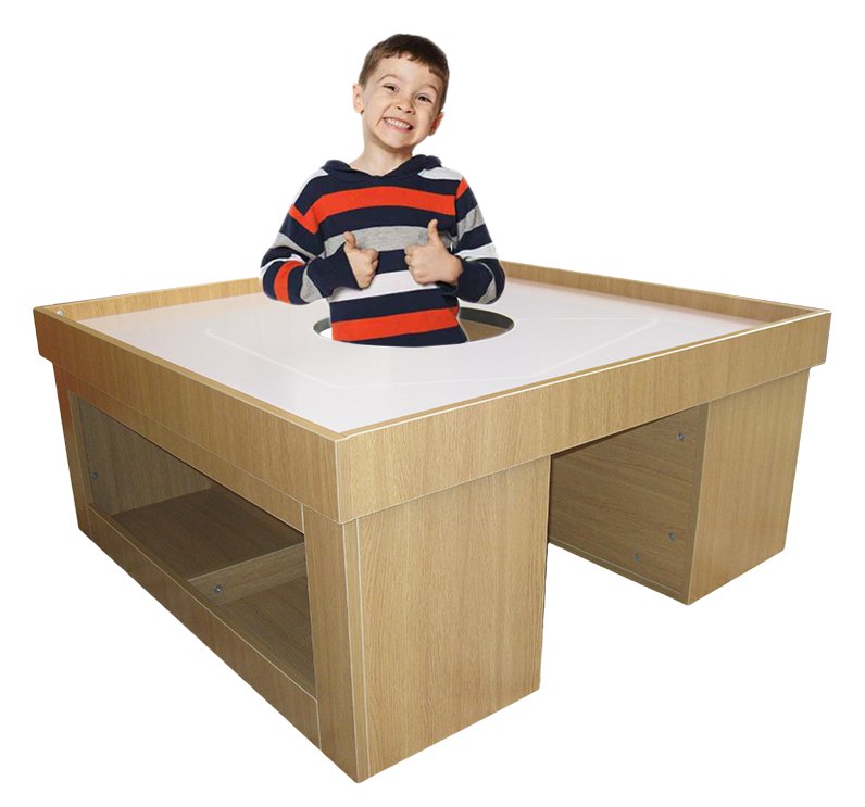 Child standing in the center opening of the Kids Play Table, whiteboard side up