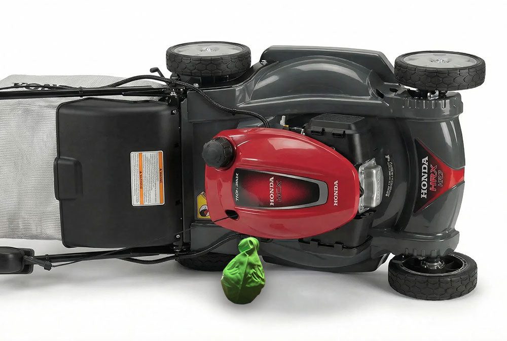 Honda mower tipped on its side with the Mow Flow Pro draining oil into a balloon